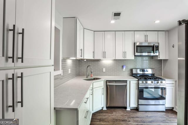 2302 Colonial Dr NE, Brookhaven, GA 30319 - kitchen featuring visible vents, stainless steel appliances, white cabinets, and a sink