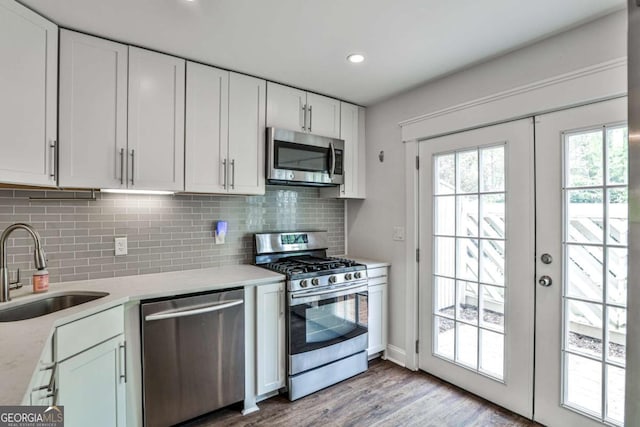 2302 Colonial Dr NE, Brookhaven, GA 30319 - kitchen with white cabinetry, backsplash, appliances with stainless steel finishes, and a sink