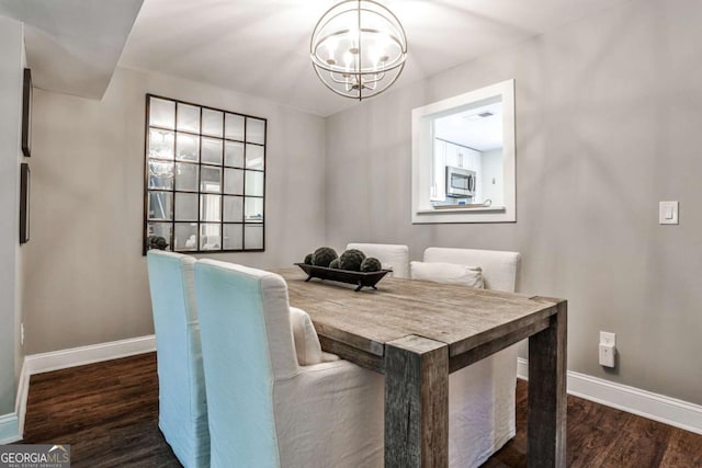 2302 Colonial Dr NE, Brookhaven, GA 30319 - dining room featuring an inviting chandelier, wood finished floors, and baseboards
