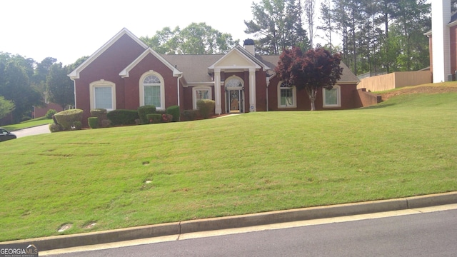 4955 Highland Lakes Dr, South Fulton, GA 30349 - greek revival house with a chimney, fence, and a front lawn