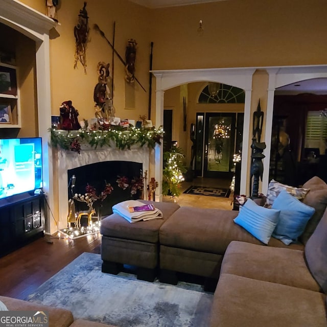 4955 Highland Lakes Dr, South Fulton, GA 30349 - living area with arched walkways, wood finished floors, and a fireplace