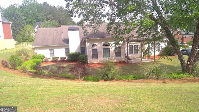 4955 Highland Lakes Dr, South Fulton, GA 30349 - view of front of house with a chimney, a pergola, a front yard, and a patio