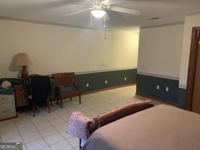 bedroom with light tile patterned flooring, visible vents, ceiling fan, and ornamental molding