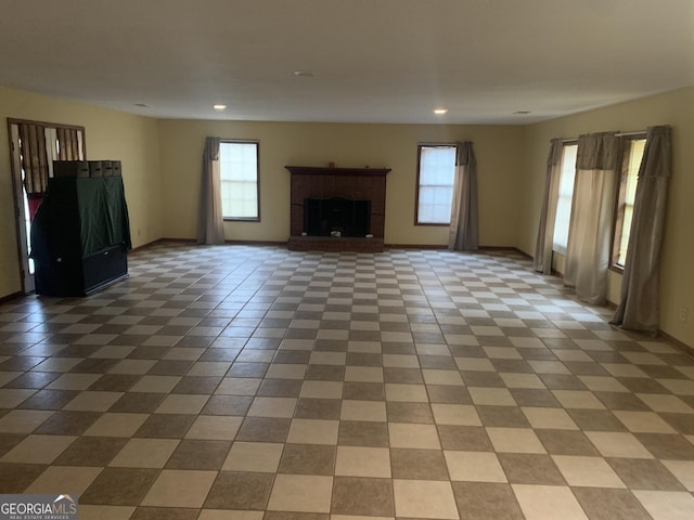 unfurnished living room featuring recessed lighting, baseboards, and a healthy amount of sunlight