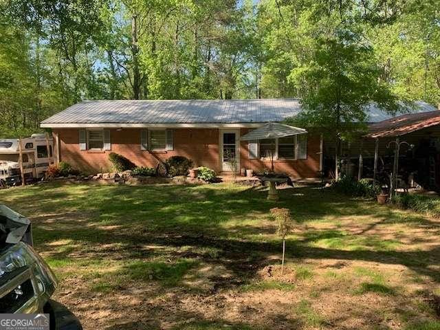 3683 Miller St, Lithia Springs, GA 30122 - back of house with metal roof and a yard