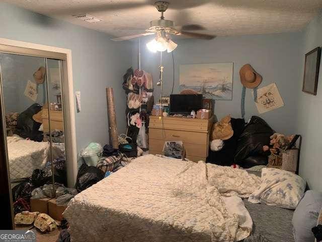 3683 Miller St, Lithia Springs, GA 30122 - bedroom with a closet, a ceiling fan, and visible vents
