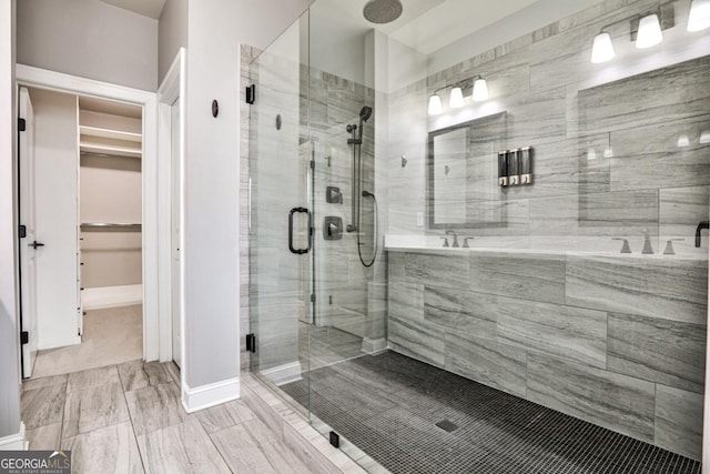 247 Franklin Rd, Atlanta, GA 30342 - bathroom with a walk in closet, baseboards, and a shower stall
