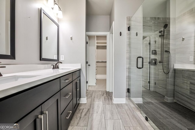 247 Franklin Rd, Atlanta, GA 30342 - bathroom with a sink, a stall shower, double vanity, and a walk in closet