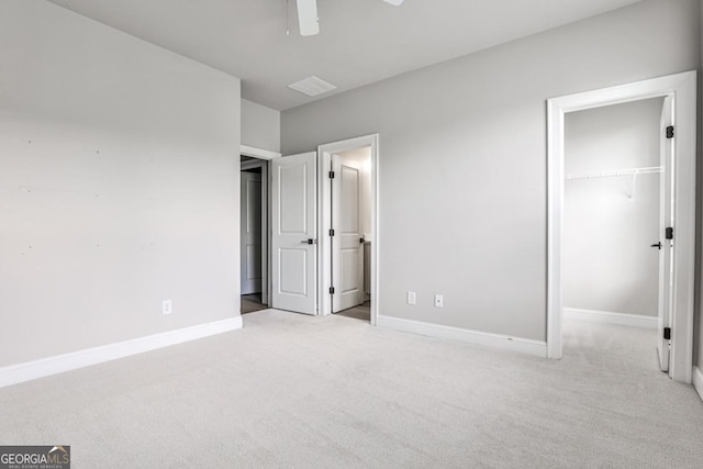 247 Franklin Rd, Atlanta, GA 30342 - unfurnished bedroom with carpet flooring, a closet, a ceiling fan, a walk in closet, and baseboards
