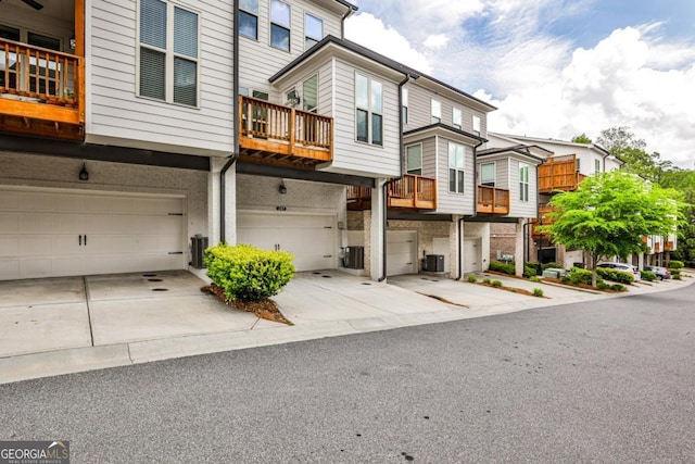 247 Franklin Rd, Atlanta, GA 30342 - view of front of home featuring cooling unit, driveway, a residential view, and an attached garage