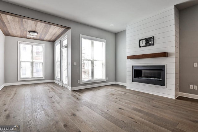 247 Franklin Rd, Atlanta, GA 30342 - unfurnished living room with dark wood-type flooring, a large fireplace, and baseboards