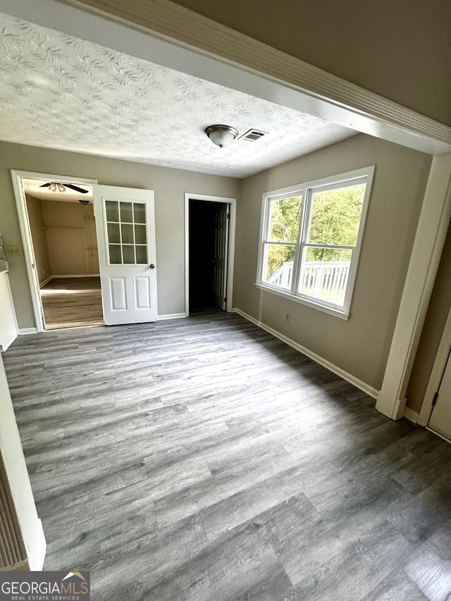 2204 Liberty Ln SW, Conyers, GA 30094 - unfurnished bedroom featuring wood finished floors, a closet, and a textured ceiling