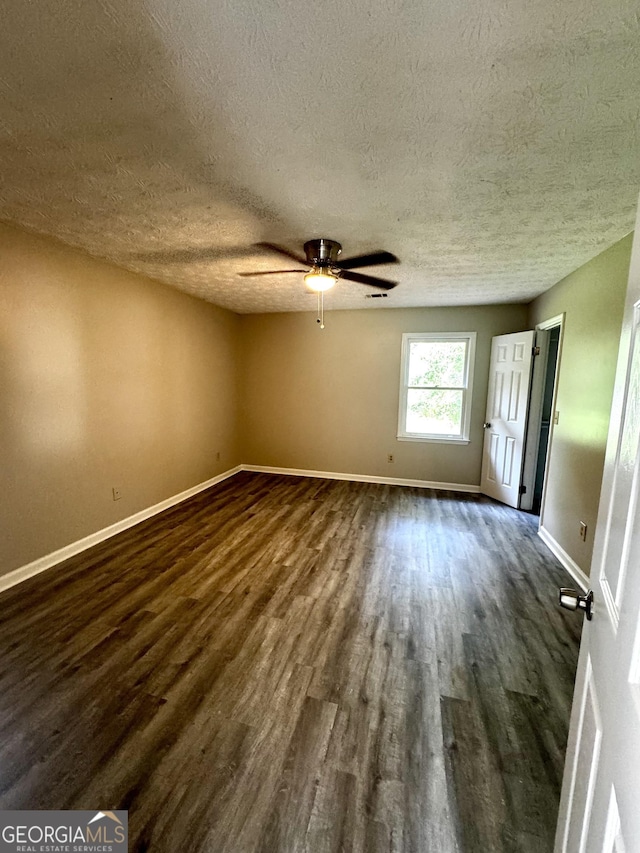 2204 Liberty Ln SW, Conyers, GA 30094 - unfurnished room featuring dark wood-type flooring, a textured ceiling, and ceiling fan