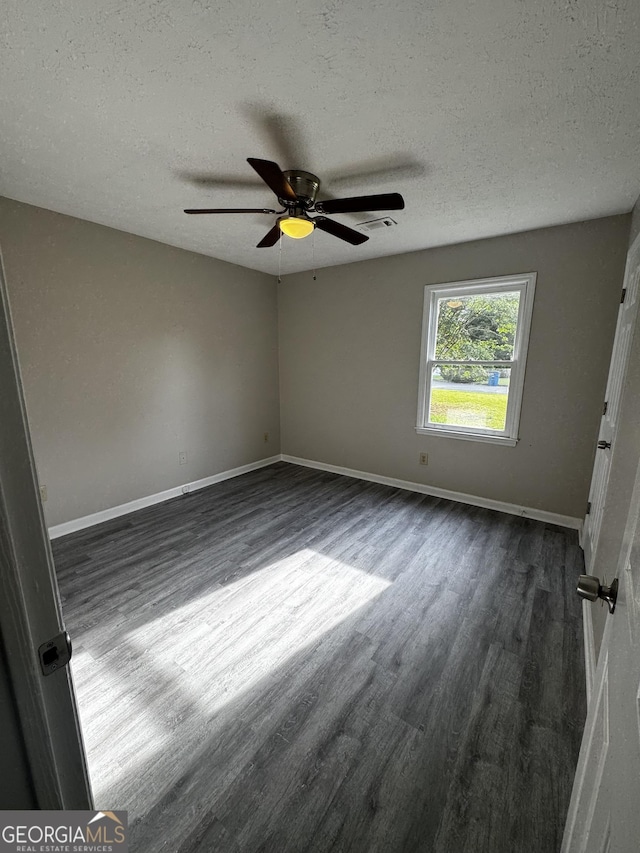 2204 Liberty Ln SW, Conyers, GA 30094 - unfurnished room with dark wood-style flooring, ceiling fan, and a textured ceiling