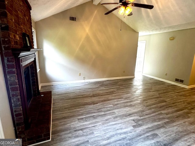 2204 Liberty Ln SW, Conyers, GA 30094 - unfurnished living room with ceiling fan, a brick fireplace, wood finished floors, beam ceiling, and high vaulted ceiling