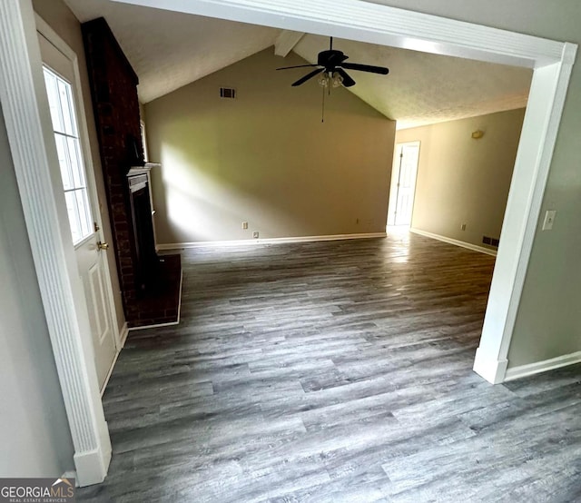 2204 Liberty Ln SW, Conyers, GA 30094 - unfurnished living room featuring a ceiling fan, wood finished floors, and a brick fireplace