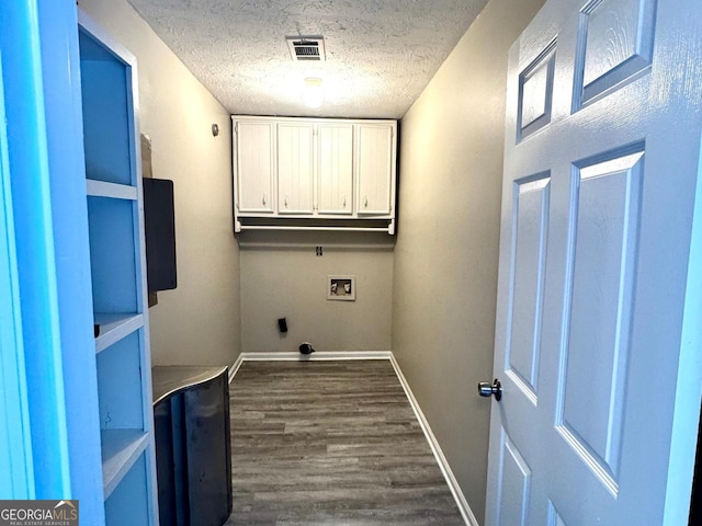 2204 Liberty Ln SW, Conyers, GA 30094 - washroom with cabinet space, washer hookup, dark wood finished floors, a textured ceiling, and electric dryer hookup
