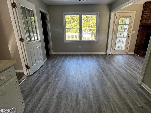 2204 Liberty Ln SW, Conyers, GA 30094 - unfurnished dining area with dark wood-type flooring and baseboards