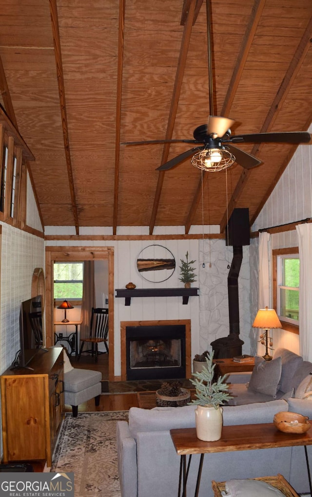 767 Robertson Cir, Blairsville, GA 30512 - living area featuring wooden ceiling, healthy amount of natural light, ceiling fan, wood finished floors, and a wood stove