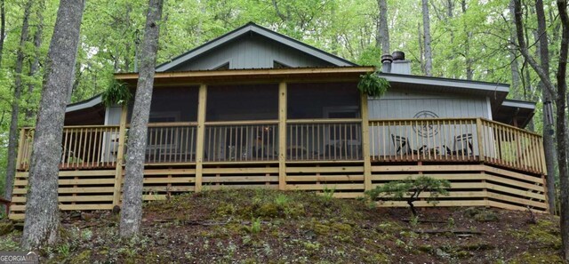 767 Robertson Cir, Blairsville, GA 30512 - rear view of house featuring a wooden deck, a chimney, and a sunroom