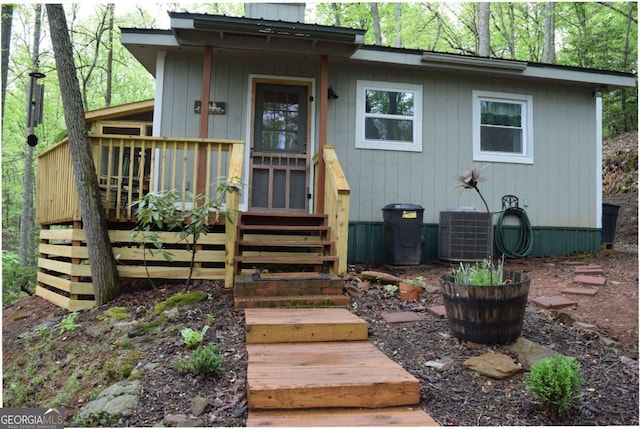 767 Robertson Cir, Blairsville, GA 30512 - doorway to property featuring central air condition unit, a wooden deck, and a chimney