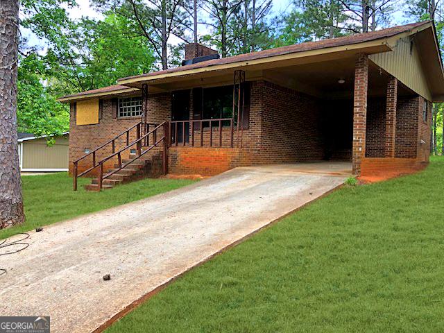 7225 Pineneedle Dr SW, Covington, GA 30014 - ranch-style home with brick siding, concrete driveway, a front yard, and a chimney