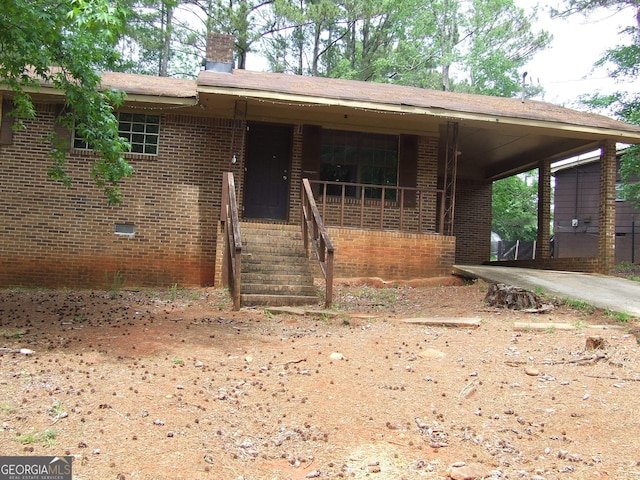 7225 Pineneedle Dr SW, Covington, GA 30014 - view of front of home featuring brick siding, covered porch, and a chimney