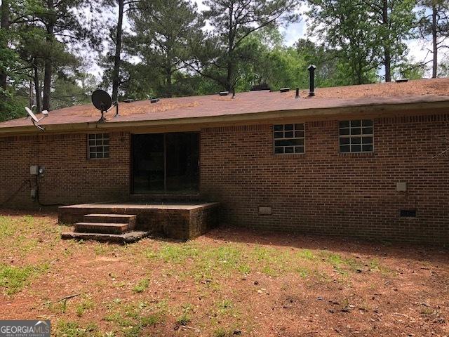 7225 Pineneedle Dr SW, Covington, GA 30014 - back of house with crawl space, brick siding, and a patio area