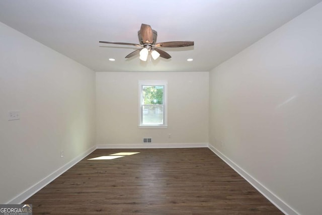 empty room with ceiling fan, visible vents, dark wood finished floors, baseboards, and recessed lighting