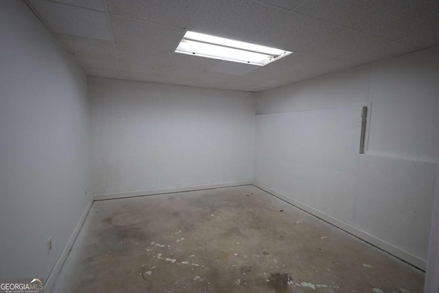 below grade area featuring baseboards and a paneled ceiling