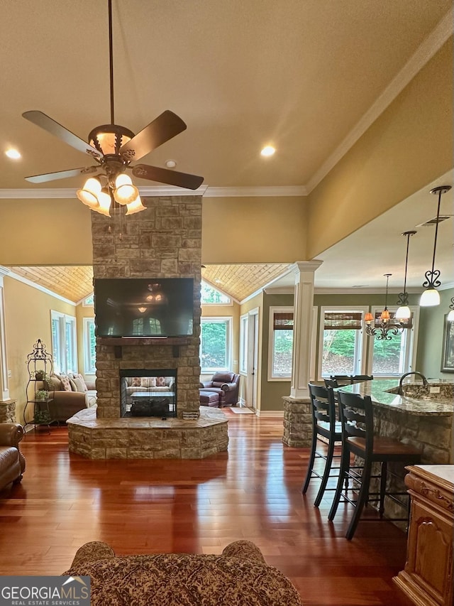 3397 Holly Glen Dr, Dacula, GA 30019 - living area featuring crown molding, ceiling fan, a fireplace, and dark wood-style flooring