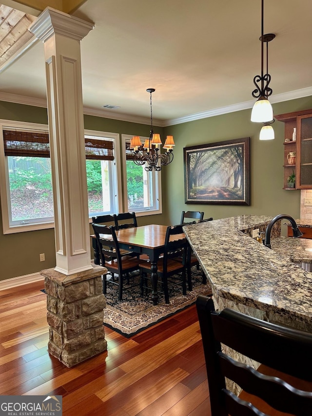 3397 Holly Glen Dr, Dacula, GA 30019 - dining room featuring ornamental molding, wood-type flooring, ornate columns, and visible vents