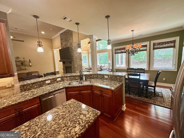 3397 Holly Glen Dr, Dacula, GA 30019 - kitchen with a sink, a stone fireplace, open floor plan, stainless steel dishwasher, and ornamental molding