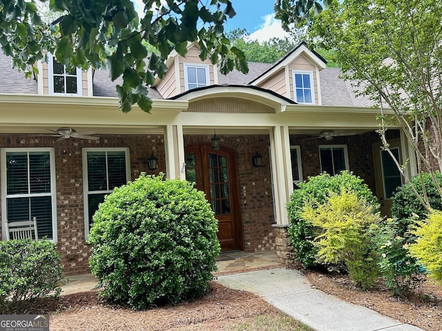 3397 Holly Glen Dr, Dacula, GA 30019 - property entrance with a porch, brick siding, ceiling fan, and roof with shingles