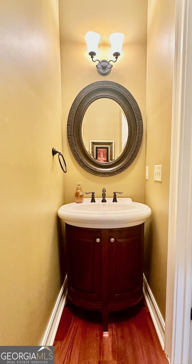 3397 Holly Glen Dr, Dacula, GA 30019 - bathroom featuring a sink, baseboards, and wood finished floors