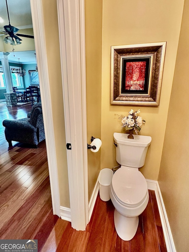 3397 Holly Glen Dr, Dacula, GA 30019 - bathroom with baseboards, ceiling fan with notable chandelier, wood finished floors, and toilet