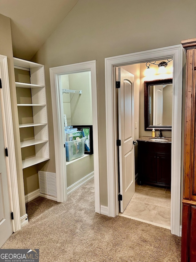 3397 Holly Glen Dr, Dacula, GA 30019 - interior space with a sink, vaulted ceiling, light colored carpet, and visible vents