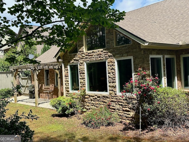 3397 Holly Glen Dr, Dacula, GA 30019 - view of front of property with fence, a pergola, a shingled roof, and stone siding