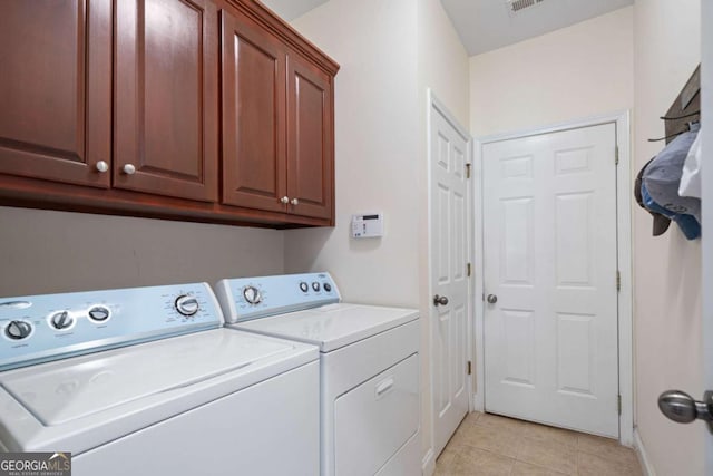 washroom with washer and dryer, cabinet space, baseboards, light tile patterned floors, and visible vents