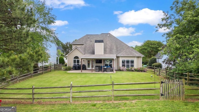 back of property featuring a yard, a patio, and a fenced backyard