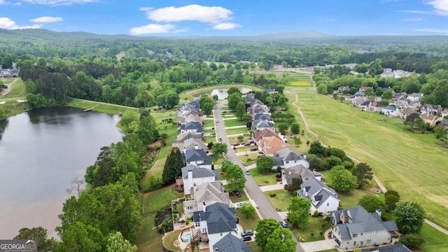 aerial view featuring a residential view, a view of trees, and a water view
