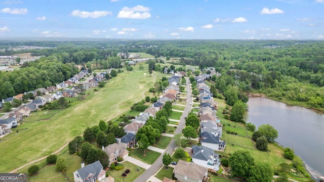 aerial view with a water view, a view of trees, and a residential view