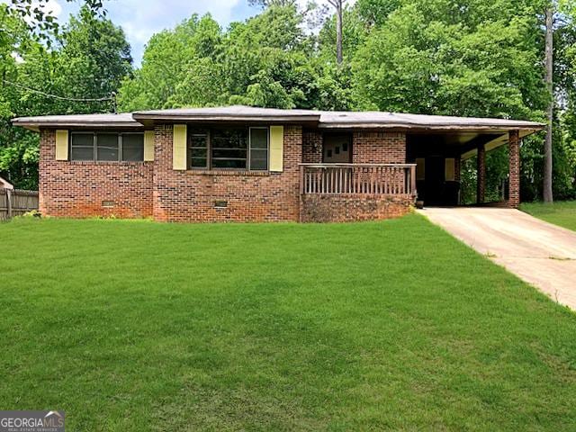 ranch-style house with concrete driveway, a front lawn, brick siding, and a carport