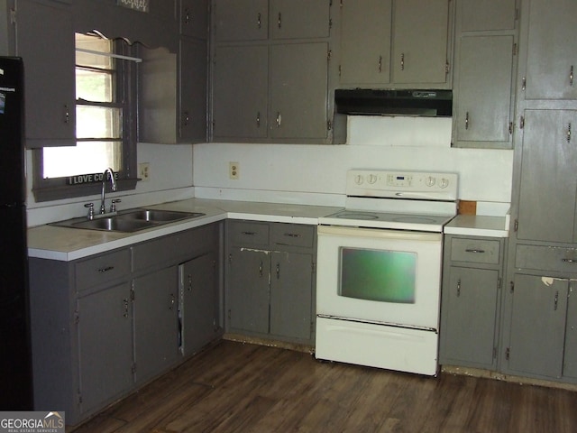 kitchen with white range with electric cooktop, exhaust hood, a sink, dark wood-type flooring, and light countertops