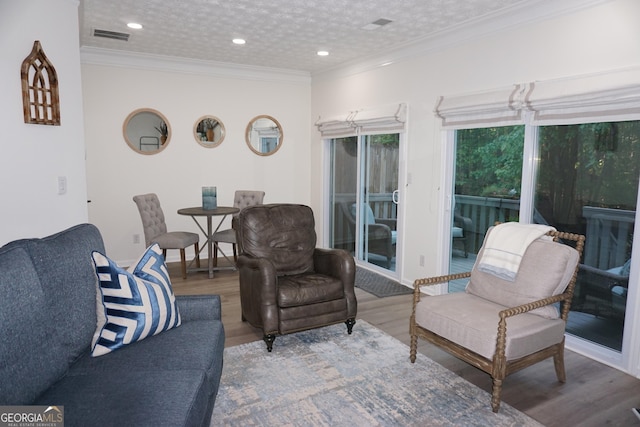 2566 Summit Cove Dr, Duluth, GA 30097 - living room featuring wood finished floors, crown molding, and recessed lighting