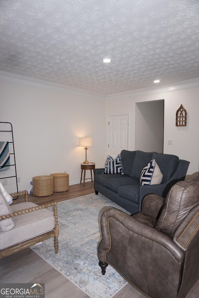 2566 Summit Cove Dr, Duluth, GA 30097 - living area featuring wood finished floors, crown molding, a textured ceiling, and recessed lighting