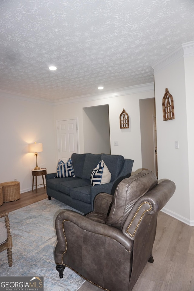 2566 Summit Cove Dr, Duluth, GA 30097 - living room featuring light wood-style floors, recessed lighting, a textured ceiling, baseboards, and crown molding