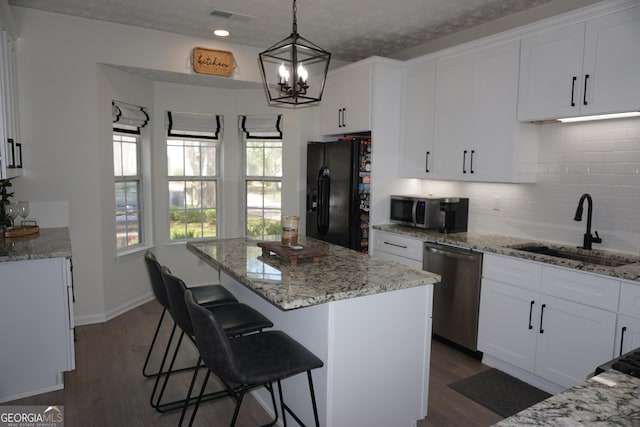 2566 Summit Cove Dr, Duluth, GA 30097 - kitchen with appliances with stainless steel finishes, a sink, backsplash, and white cabinetry