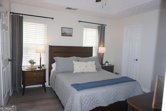 2566 Summit Cove Dr, Duluth, GA 30097 - bedroom featuring multiple windows, wood finished floors, and baseboards