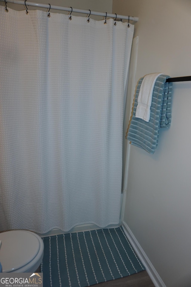2566 Summit Cove Dr, Duluth, GA 30097 - bathroom with toilet and shower / bath combination with curtain